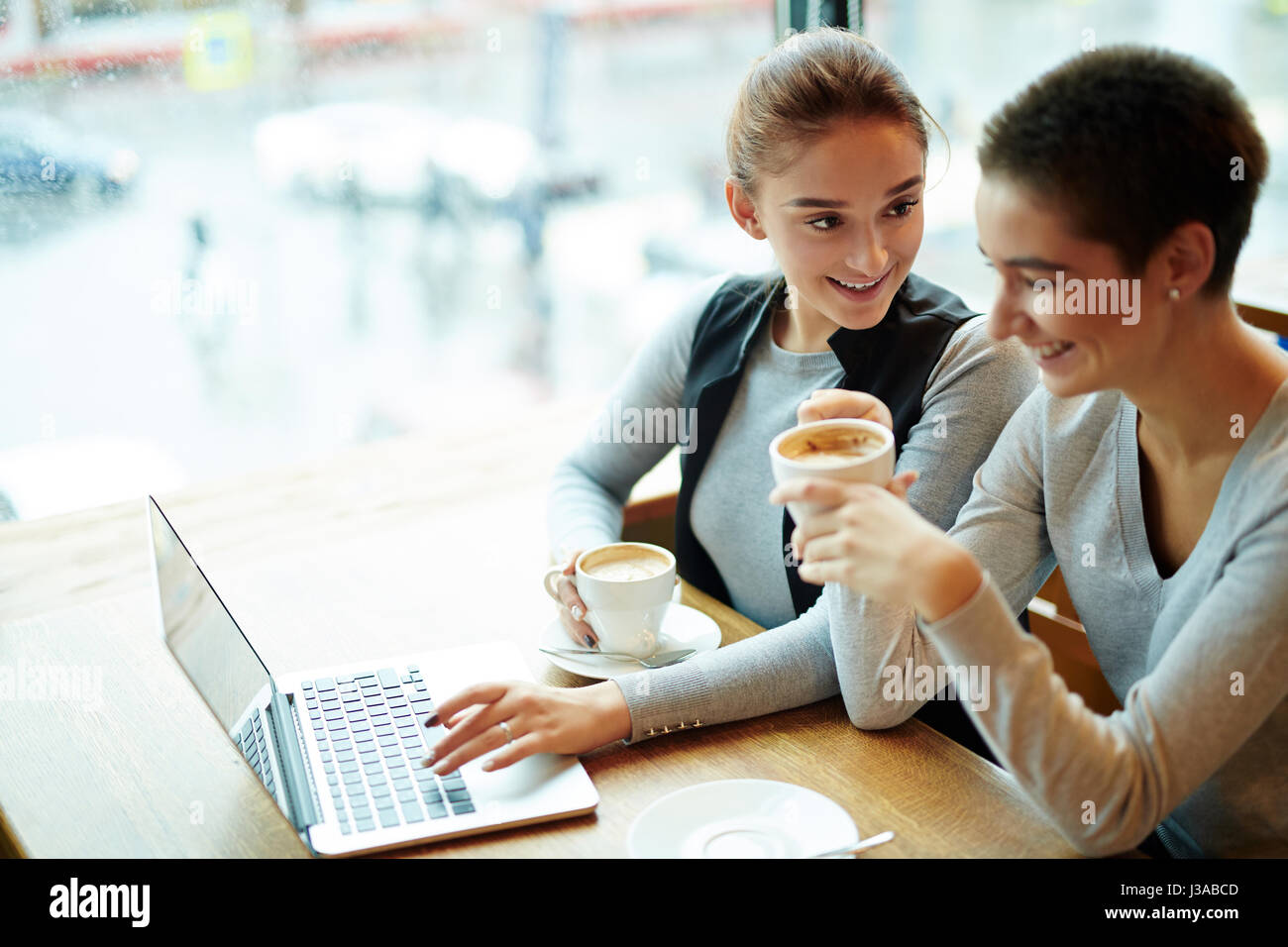 Chatting with Friend in Coffeehouse Stock Photo