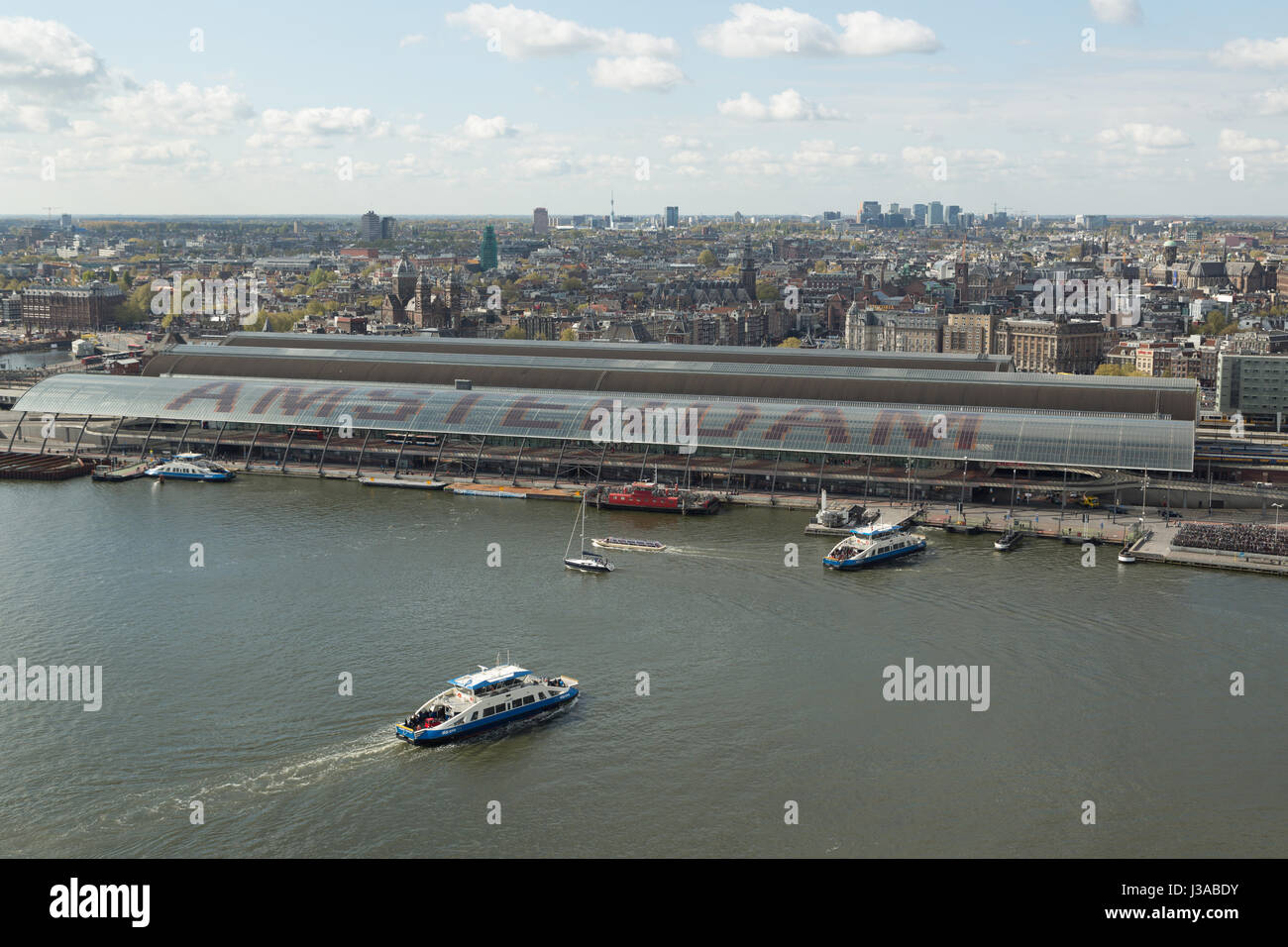 A photograph of the roof of Centraal Train Station in Amsterdam, Netherlands, as seen from the top of the Amsterdam tower on the northern side of the  Stock Photo