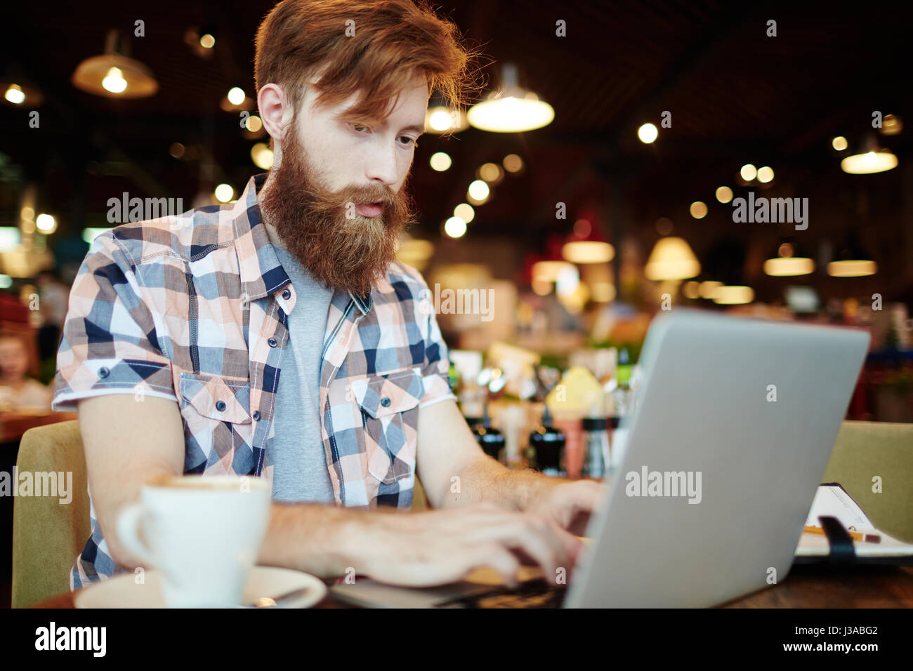 Preparing Financial Report in Cyber Cafe Stock Photo