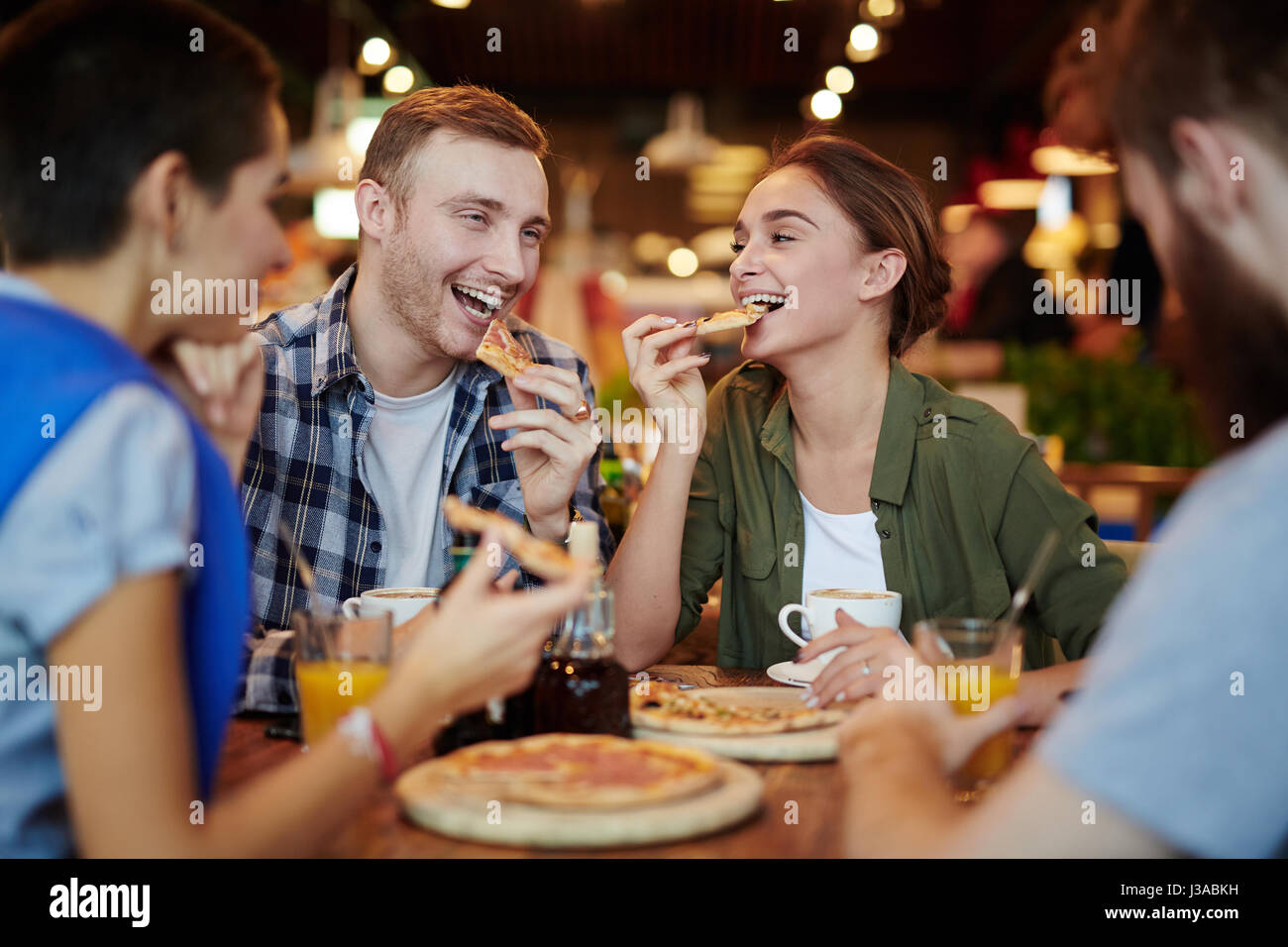 Group Of Friends Eating Pizza Together At Home Stock Photo, Picture and  Royalty Free Image. Image 56950664.