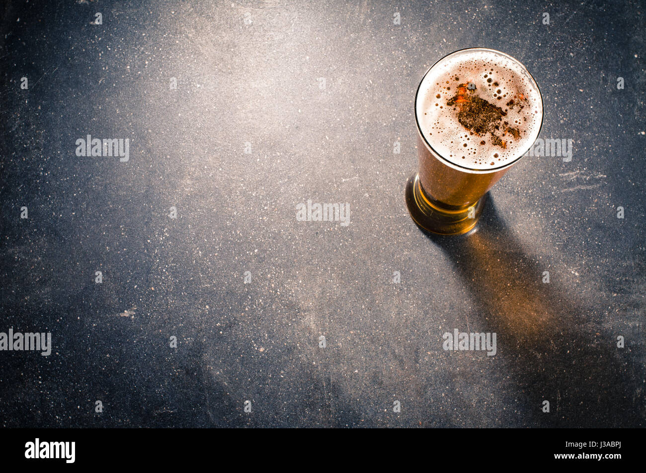 Beer glass on dark table Stock Photo