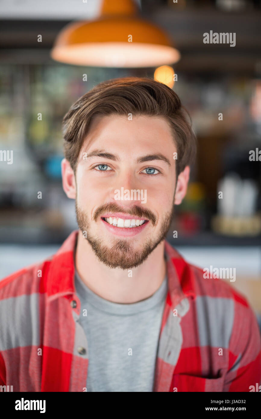 Portrait of smiling young man in pub Stock Photo