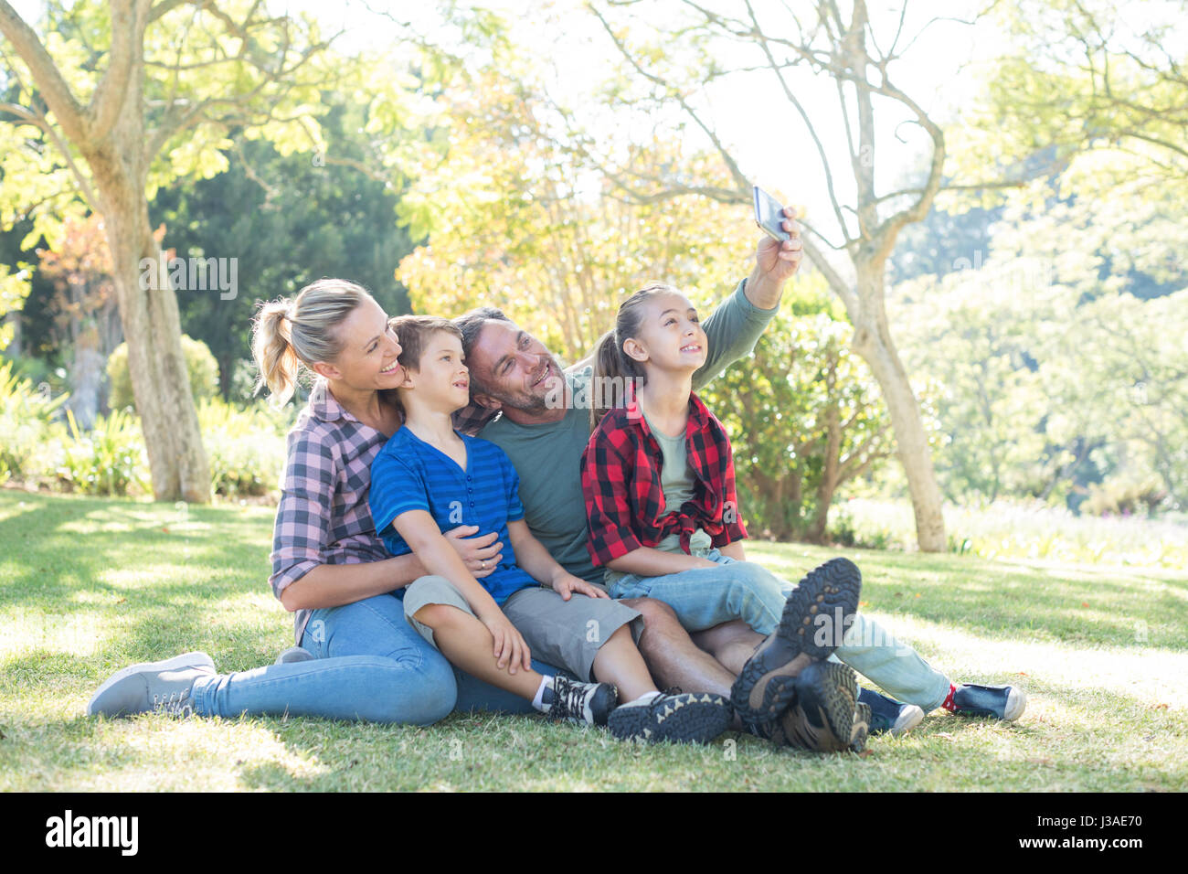 Happy family taking a selfie in the park on a sunny day Stock Photo - Alamy