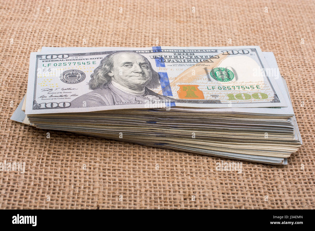 Banknote bundle of US dollar placed on a linen canvas Stock Photo - Alamy