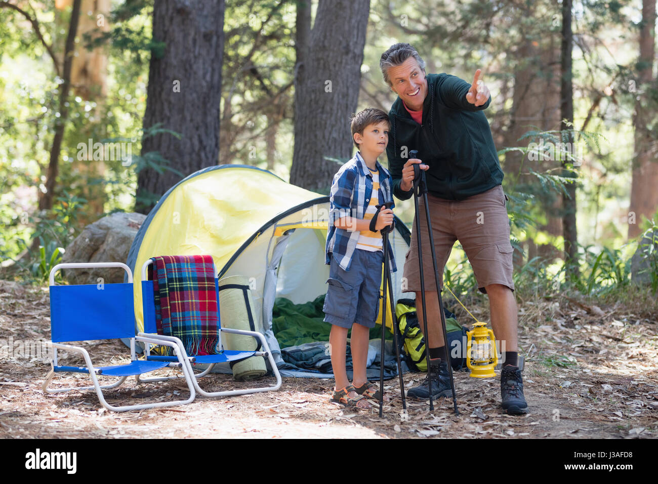 Father showing something to son while hiking in forest Stock Photo - Alamy