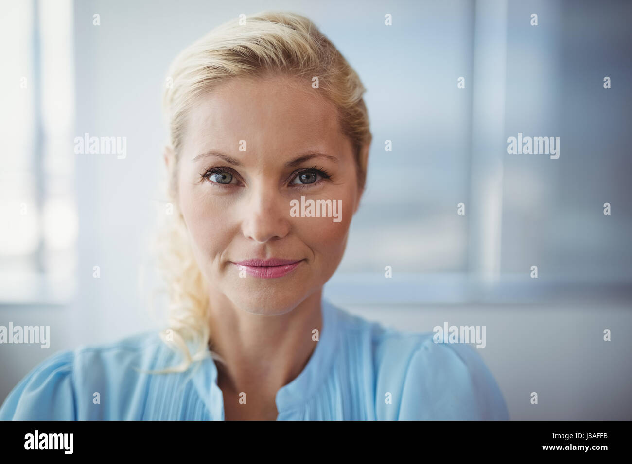 Portrait of smiling executive in office Stock Photo - Alamy