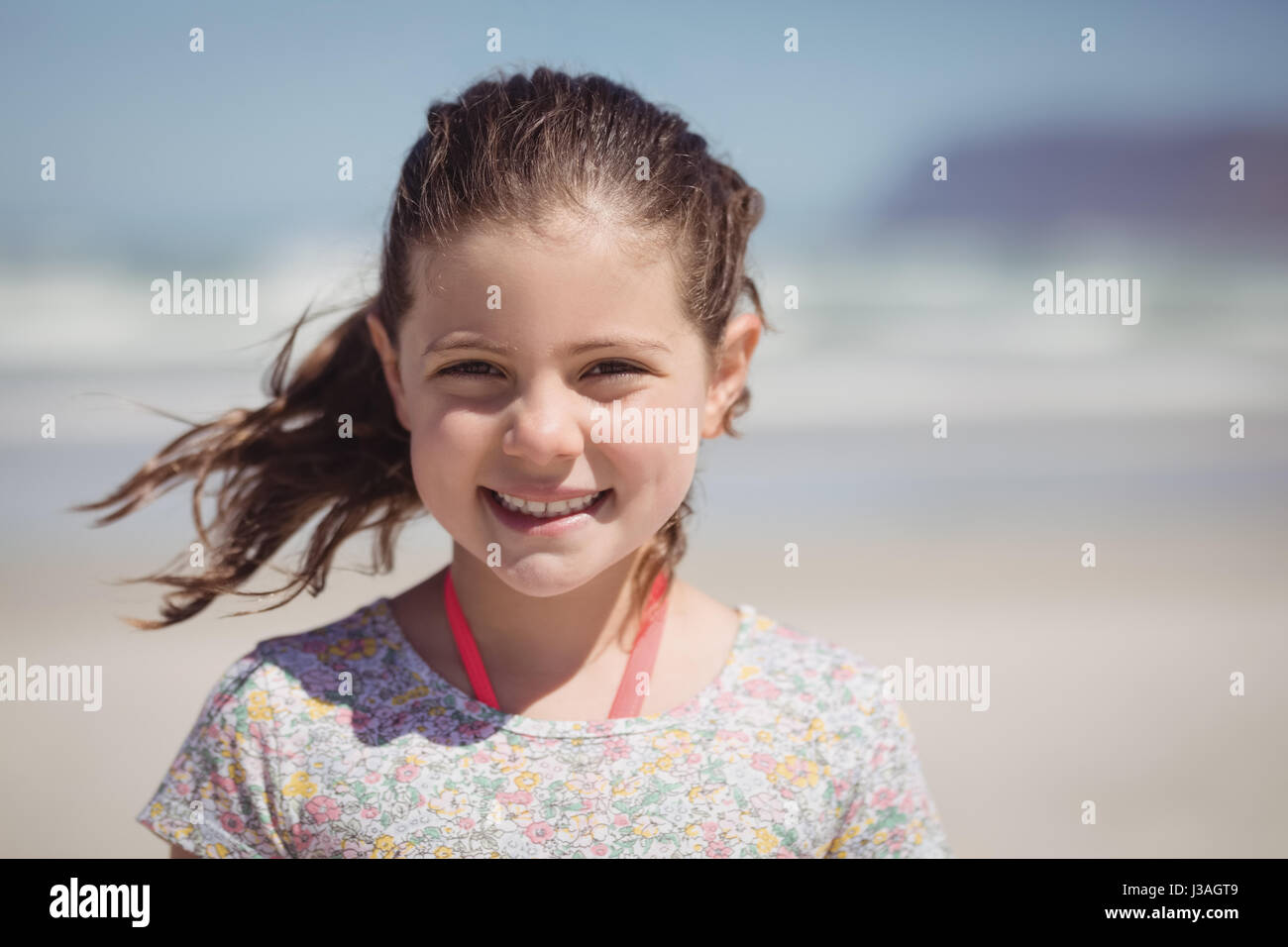 Portrait of smiling girl at beach during sunny day Stock Photo - Alamy