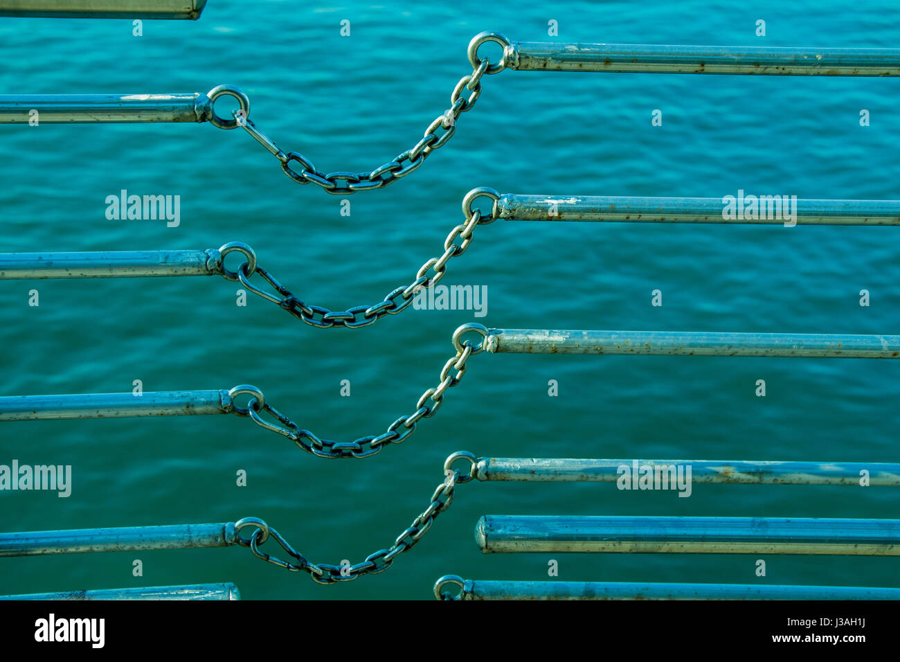 chain connects two metal bars over a body of water Stock Photo Alamy