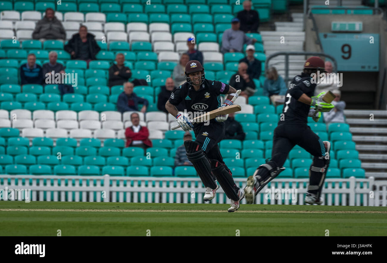 Surrey batsman run between the wickets at the Oval Stock Photo