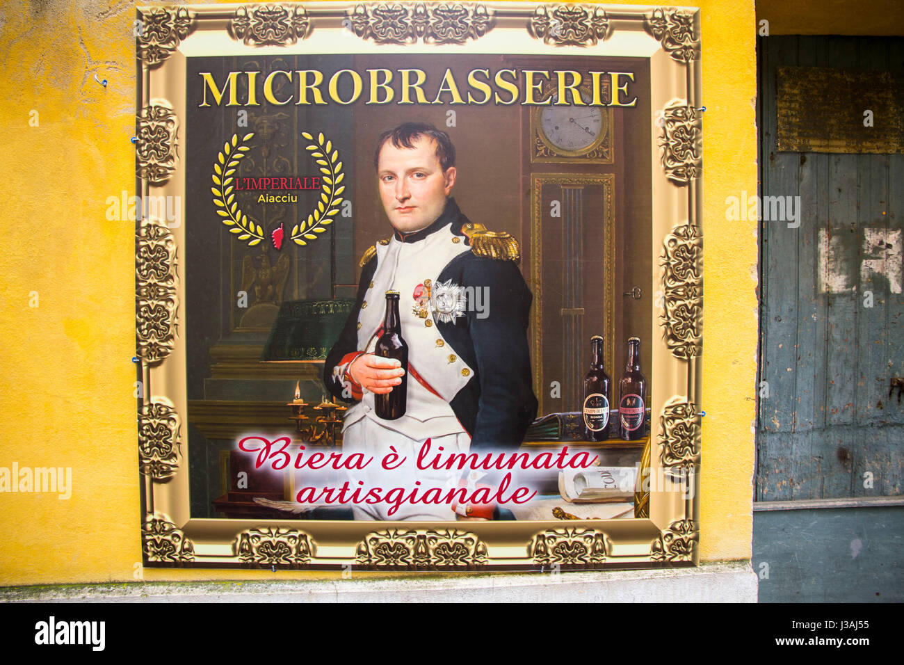 A micro-brewery adjacent Maison Bonaparte (Napoleon's ancestral home) features a poster of the self-proclaimed Emperor of France.  Ajaccio, Corsica. Stock Photo