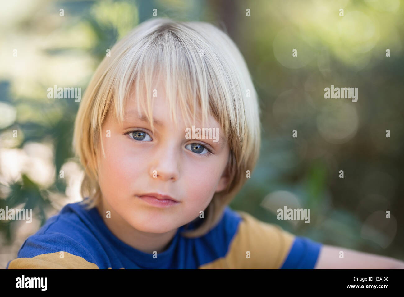 Close up portrait of cute little boy in forest Stock Photo - Alamy