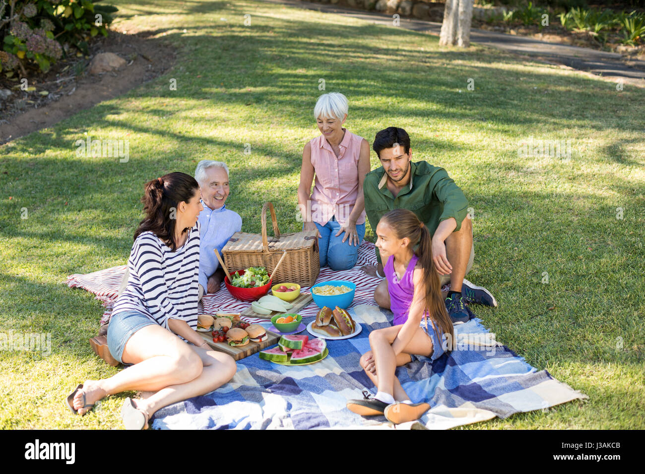 Happy family having picnic in the park on a sunny day Stock Photo - Alamy