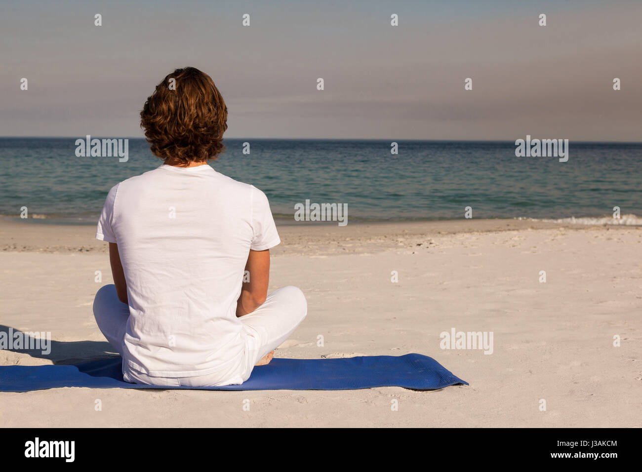 Rear view man meditating sitting hi-res stock photography and images ...