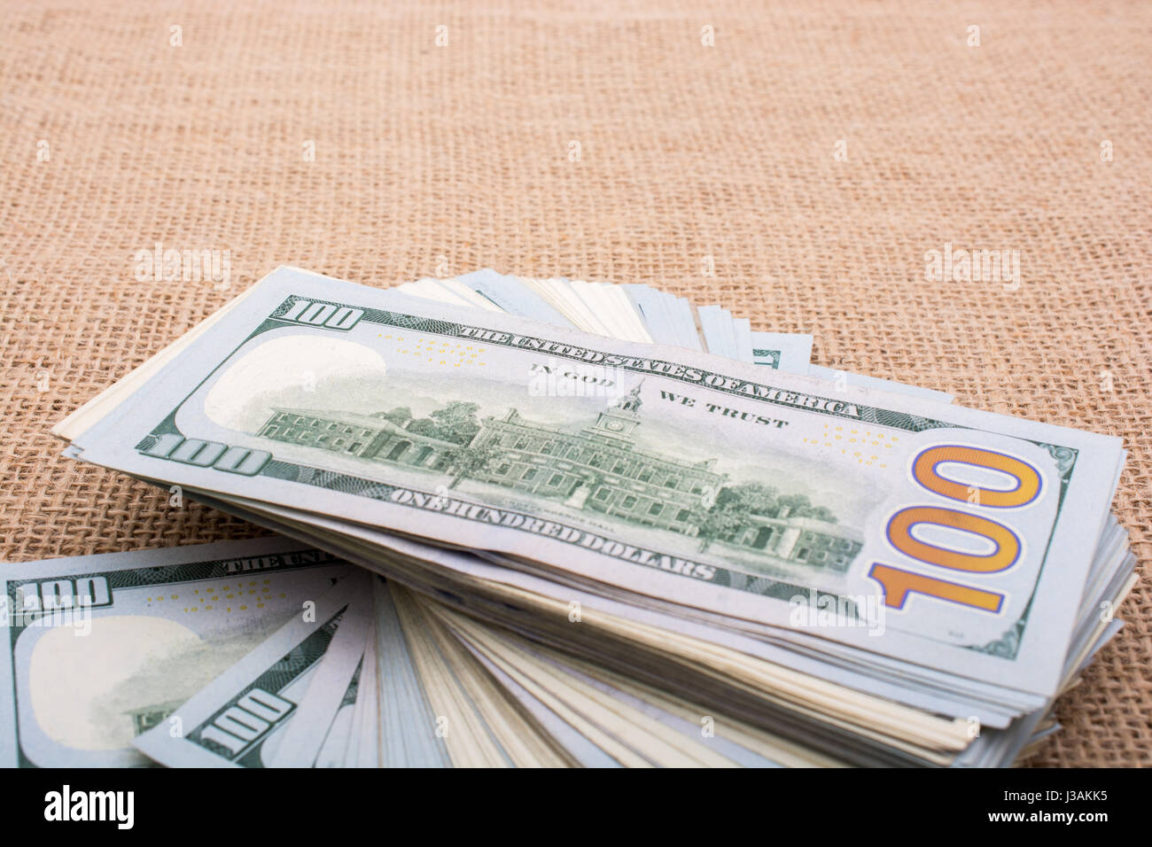 Banknote bundle of US dollar placed on a linen canvas Stock Photo - Alamy