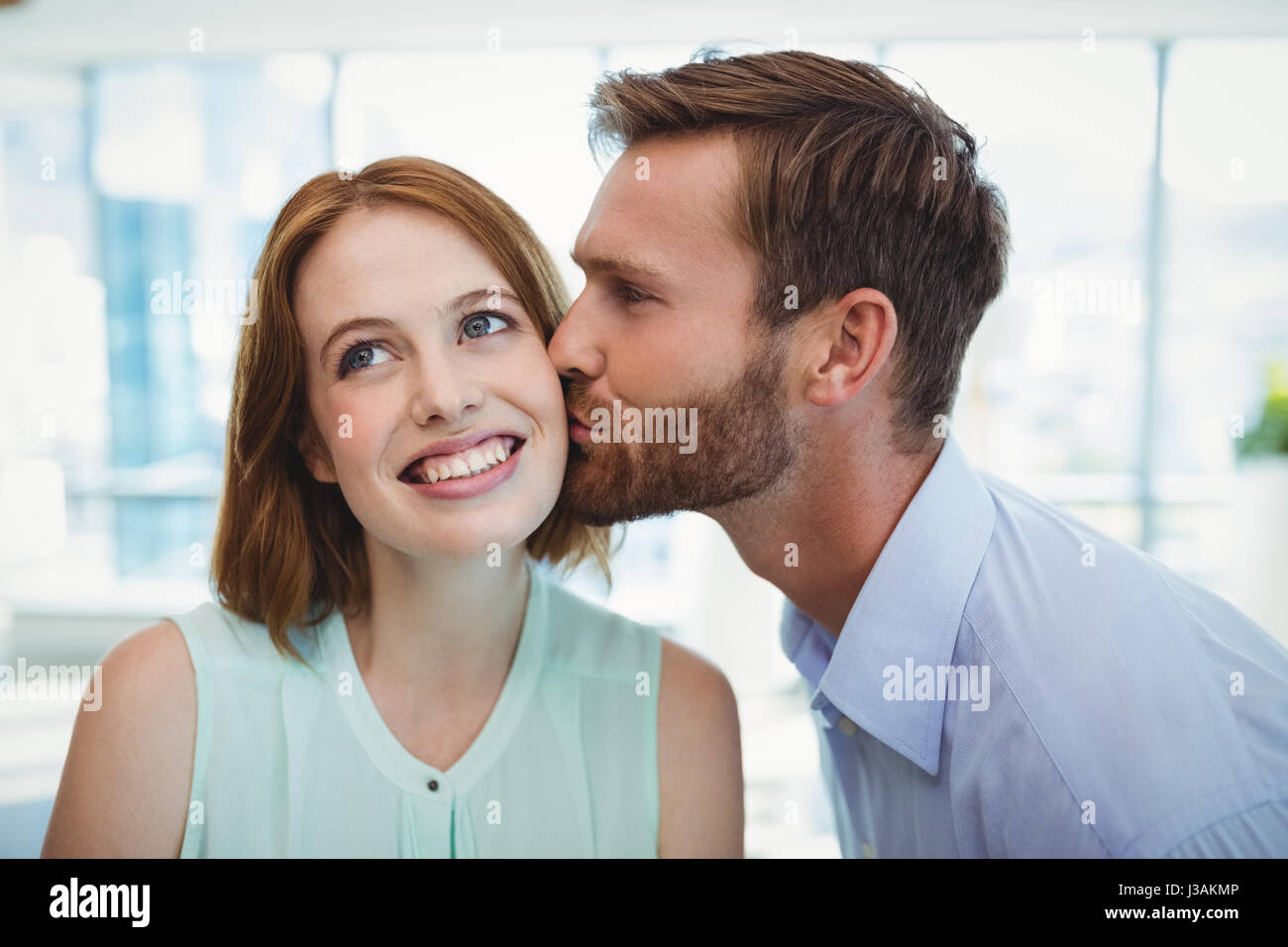 https://c8.alamy.com/comp/J3AKMP/affectionate-man-kissing-woman-in-office-J3AKMP.jpg