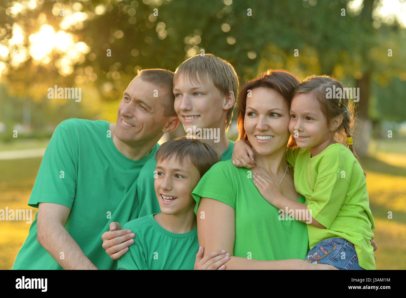 Happy parents with children at sunset Stock Photo