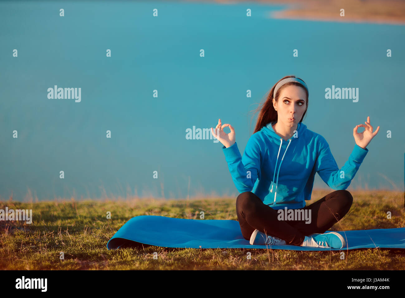 Funny Girl Meditating on Yoga Mat in Nature Stock Photo - Alamy