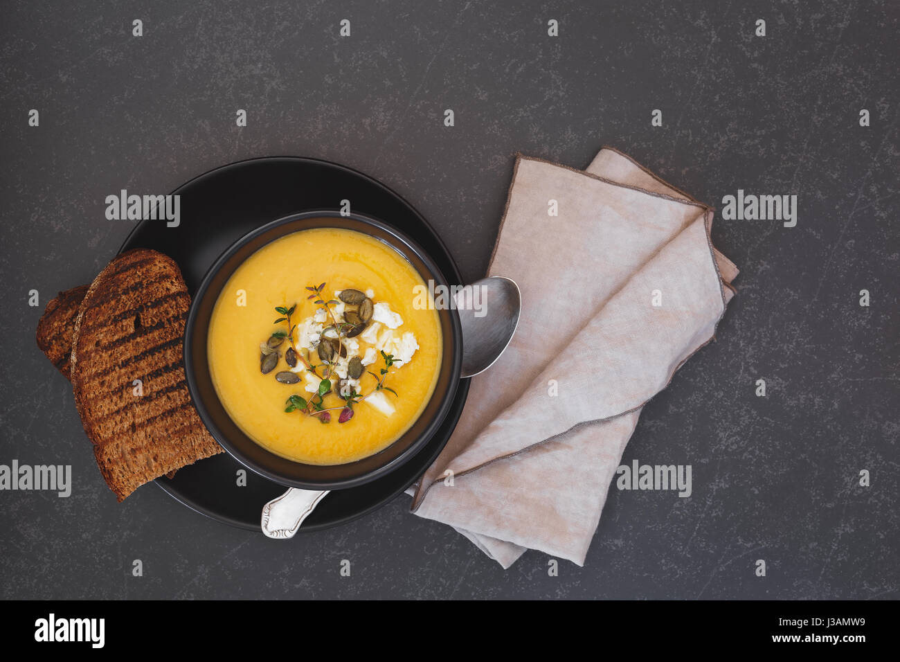 Roast pumpkin soup with pumpkin seeds.  Top view, blank space Stock Photo