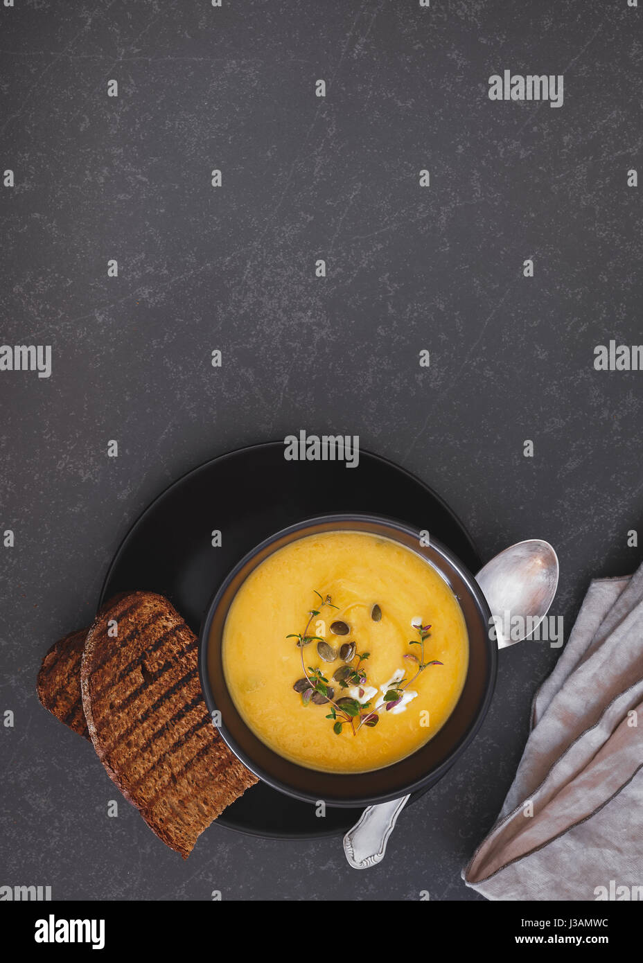 Roast pumpkin soup with pumpkin seeds.  Top view, blank space Stock Photo