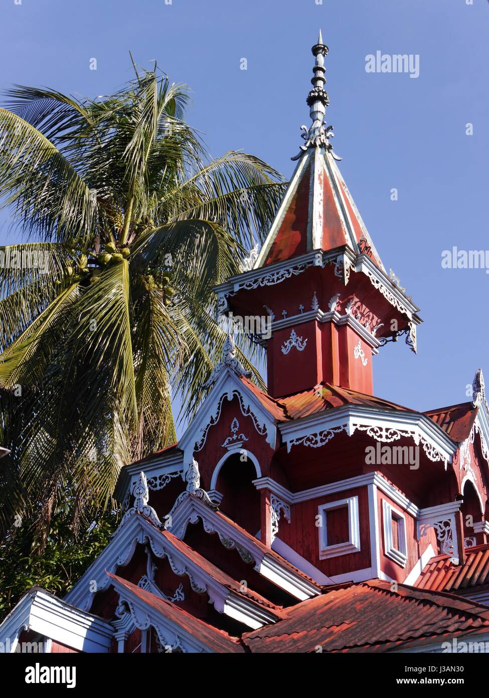 Beautiful unique red house with turret and  fancy eaves in Mawlamyine, Mon State, once capital of British Burma, one-time home to Orwell and Kipling Stock Photo