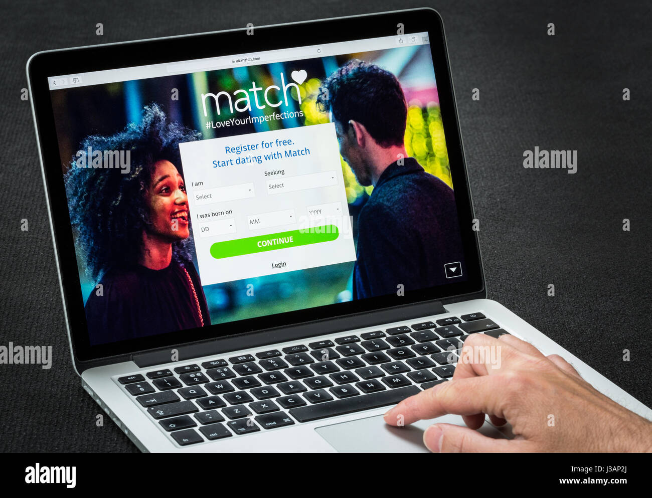 A man using Match online dating website ( match.com ) Stock Photo