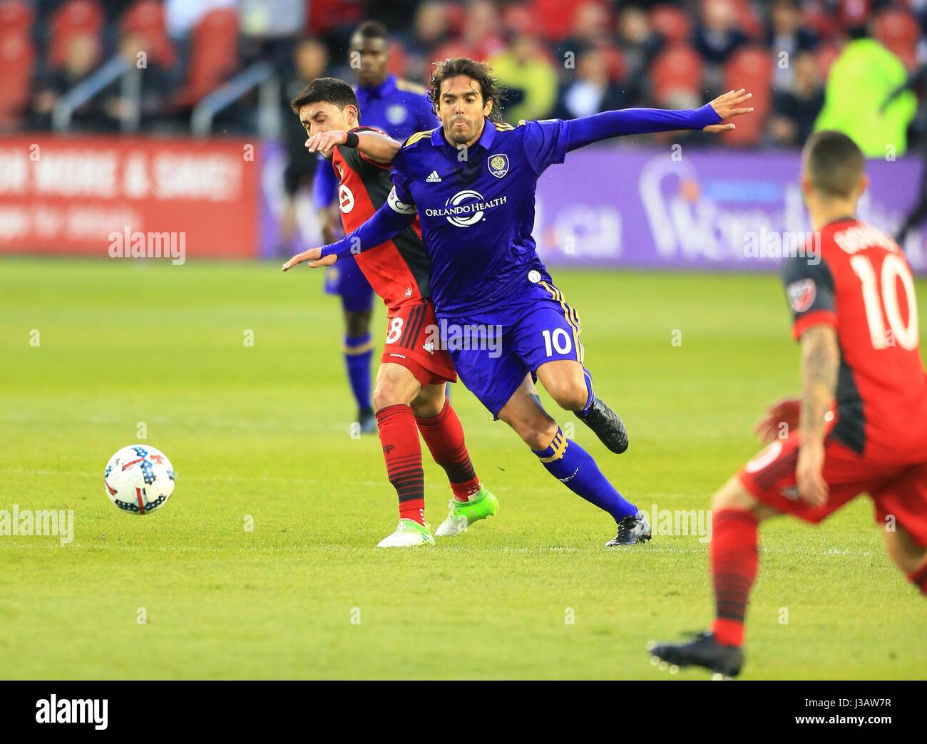 (170504) -- TORONTO, May 4, 2017(Xinhua)-- Marco Delgado (L) of Toronto FC vies with Kaka (2nd R) of Orlando City SC during their 2017 Major League Soccer (MLS) match at BMO Field in Toronto, Canada, May 3, 2017. Toronto FC won 2-1. (Xinhua/Zou Zheng) Stock Photo