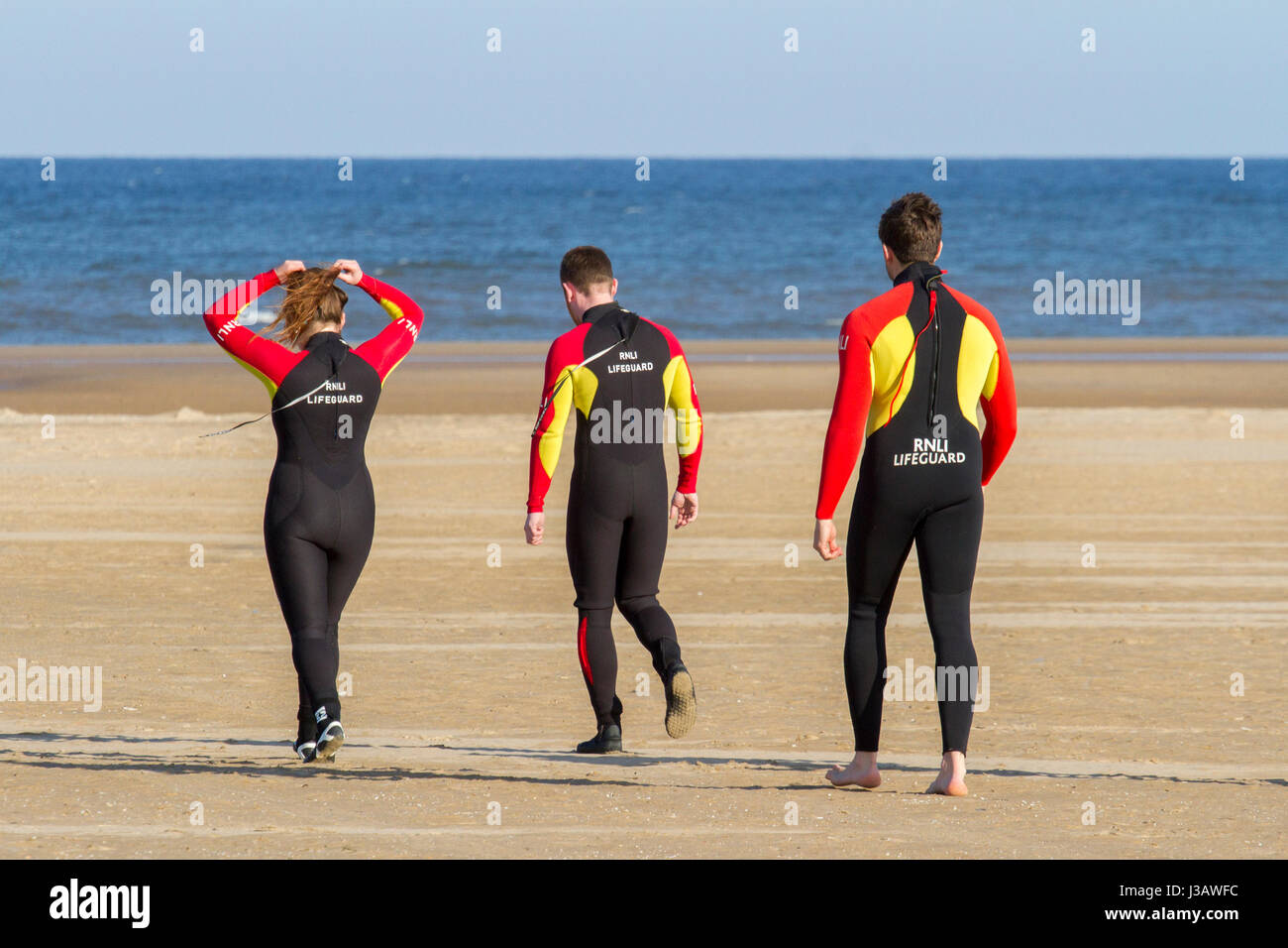 rnli lifeguard sea save rescue rescuer emergency drown drowning water tide tides safety coast swim swimmer swimming guard saver life beach seaside Stock Photo