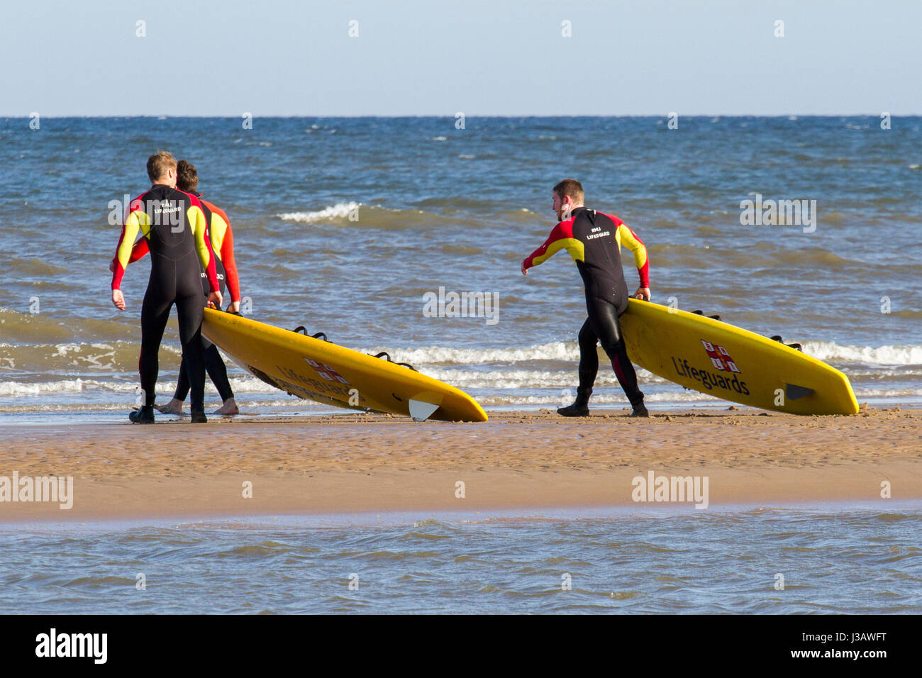 rnli lifeguard sea save rescue rescuer emergency drown drowning water tide tides safety coast swim swimmer swimming guard saver life beach seaside Stock Photo