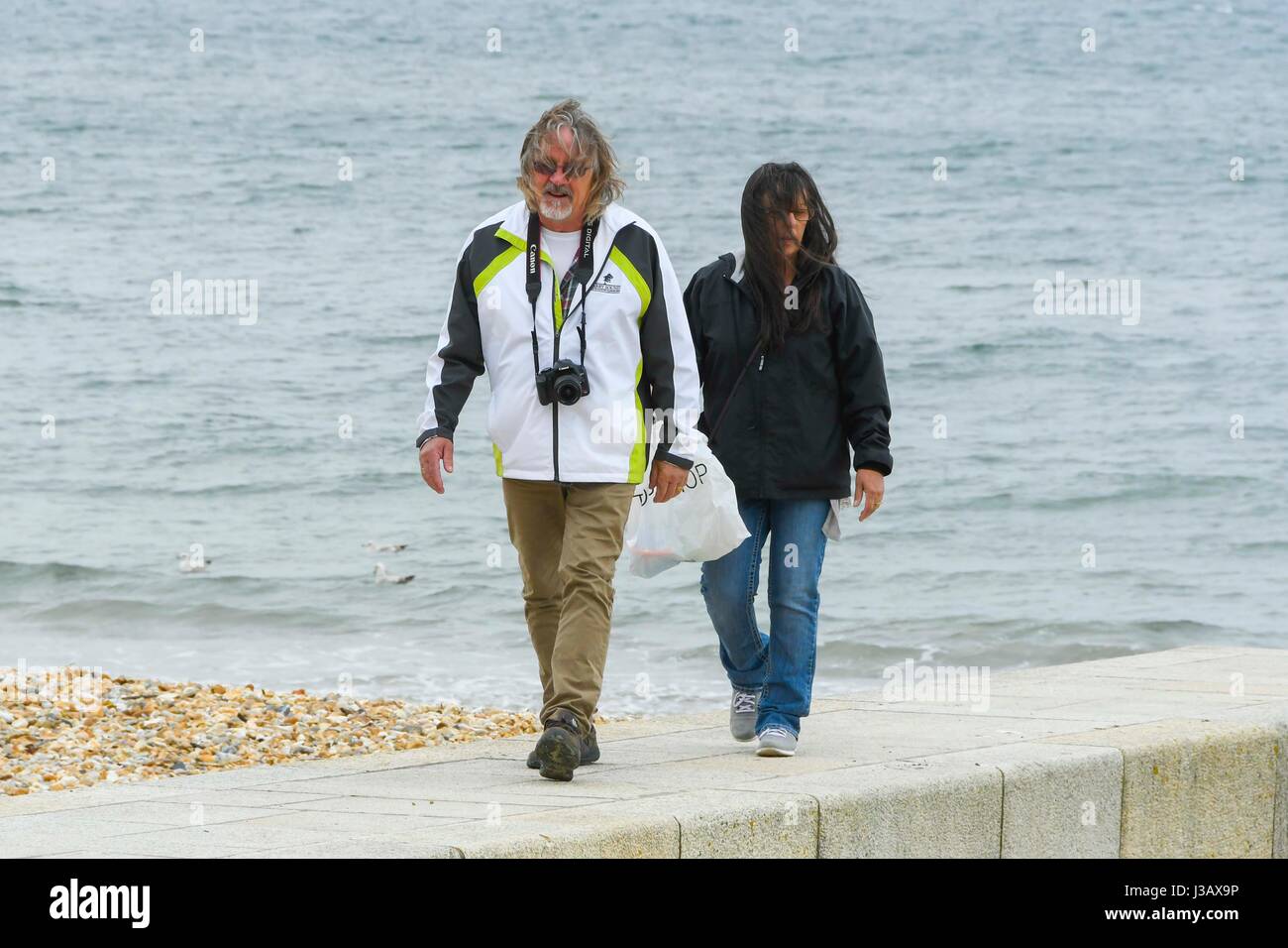 Lyme Regis, Dorset, UK. 4th May 2017.  UK Weather.  Visitors on the beach making the best of the overcast conditions at the seaside resort of Lyme Regis in Dorset.  Photo Credit: Graham Hunt/Alamy Live News Stock Photo