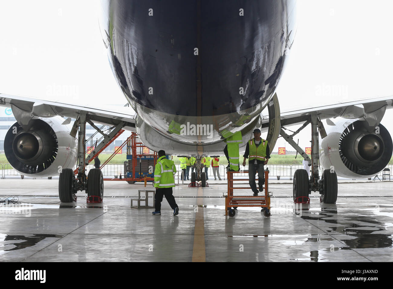Shanghai, China. 4th May, 2017. Staff workers check a C919, China's ...