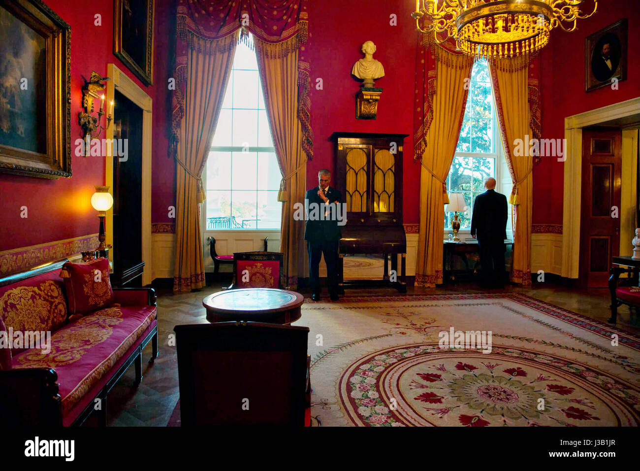 U.S. President Donald Trump, right, looks out the window from the Red Room on the State floor of the White House prior to joining  guests for an evangelical advisory board dinner May 3, 2017 in Washington, D.C. Stock Photo