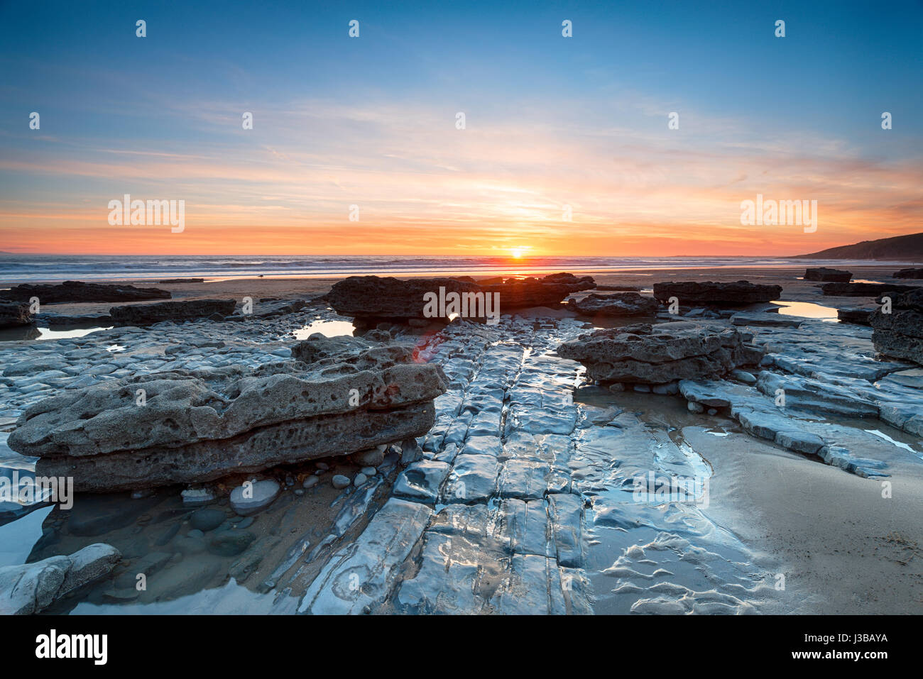 Sunset over limestone pavements at Dunraven Bay in the Vale of Glamorgan in Wales Stock Photo