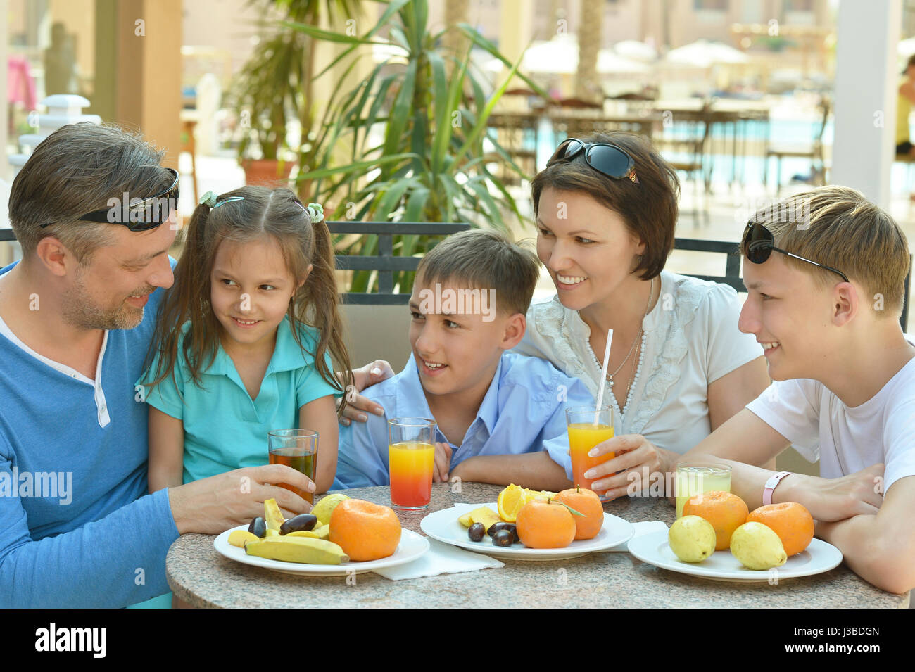 Happy parents with their children eating  Stock Photo