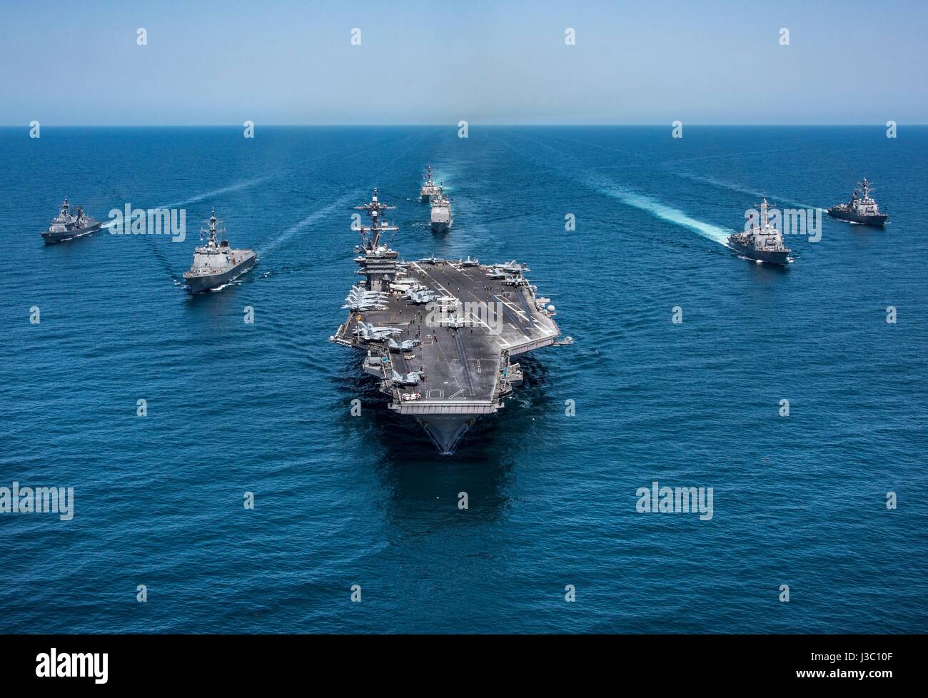 The U.S. Navy Nimitz-class aircraft carrier USS Carl Vinson underway with an escort of U.S. and South Korean warships during patrol May 3, 2017 off the coast of Korea. Stock Photo