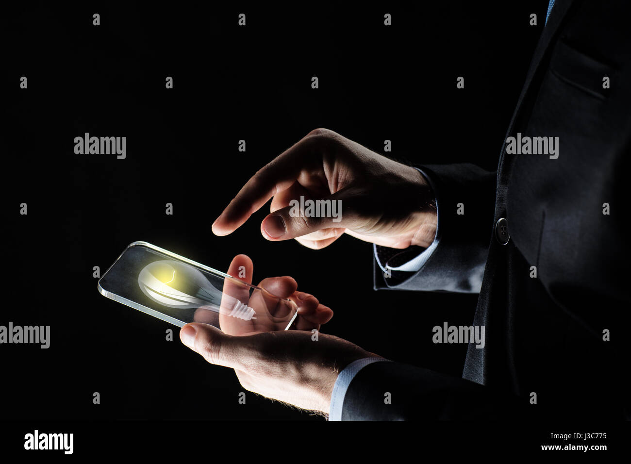 businessman with lightbulb on smartphone Stock Photo