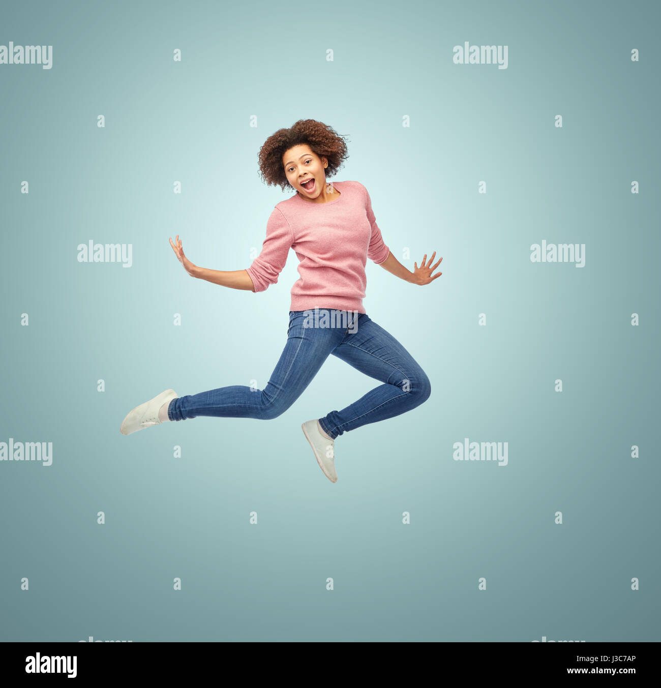 Happy african american woman jumping hi-res stock photography and