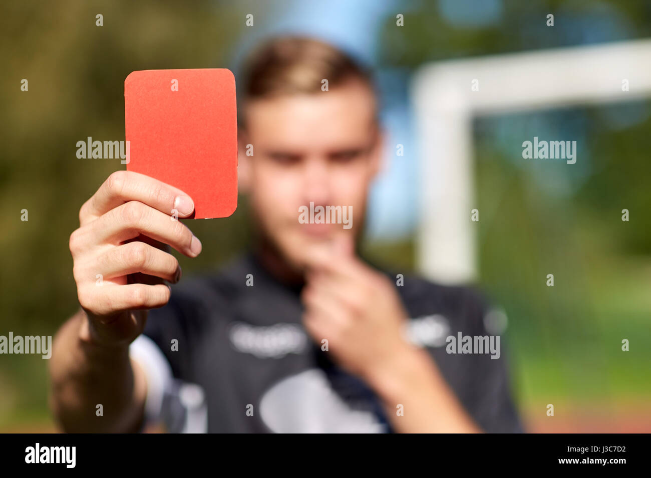 referee hands with red card on football field Stock Photo Alamy