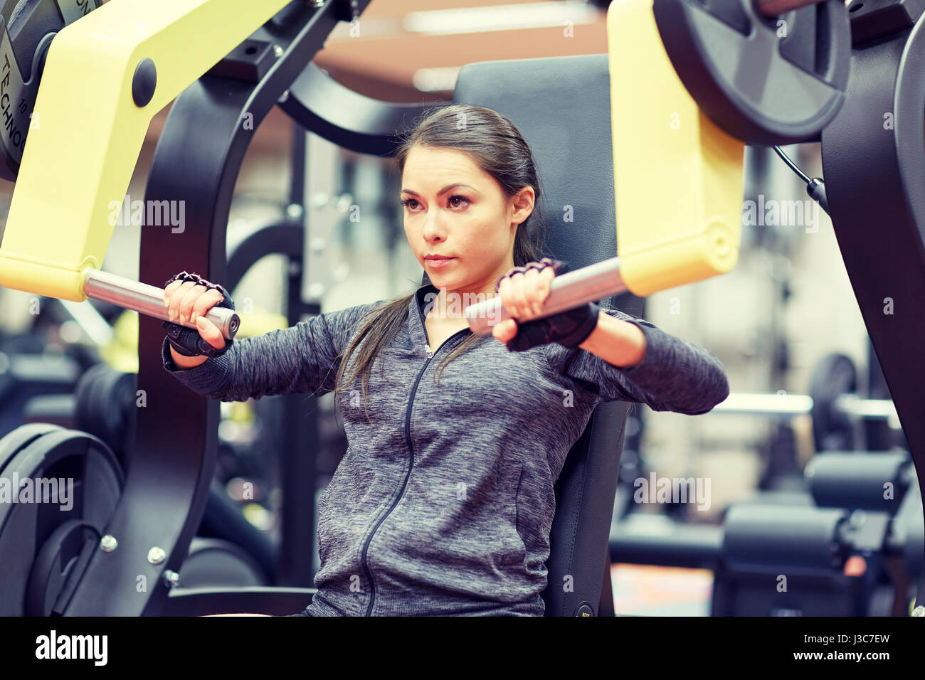 Woman trains pecs in the gym Stock Photo by ©kopitin 93164030