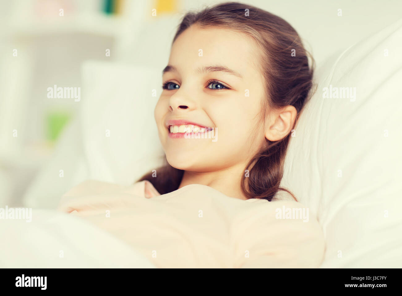 happy smiling girl lying awake in bed at home Stock Photo - Alamy