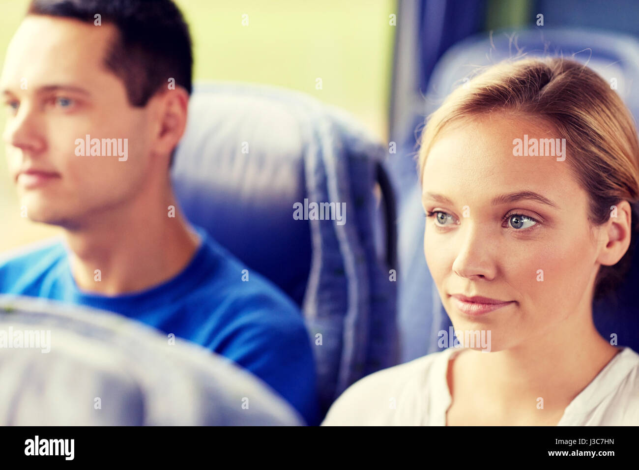 happy young woman sitting in travel bus or train Stock Photo