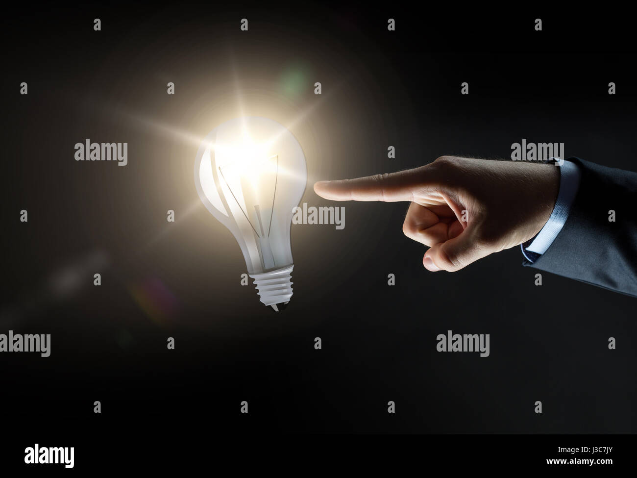 Hand touching light bulb finger hi res stock photography and