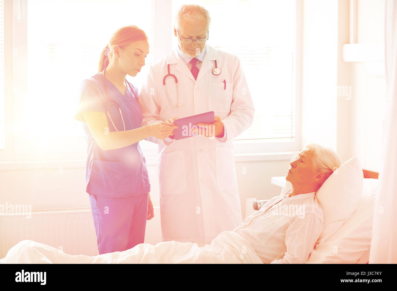 doctor and nurse visiting senior woman at hospital Stock Photo - Alamy