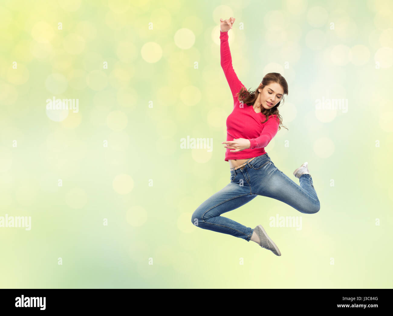 smiling young woman jumping in air Stock Photo - Alamy