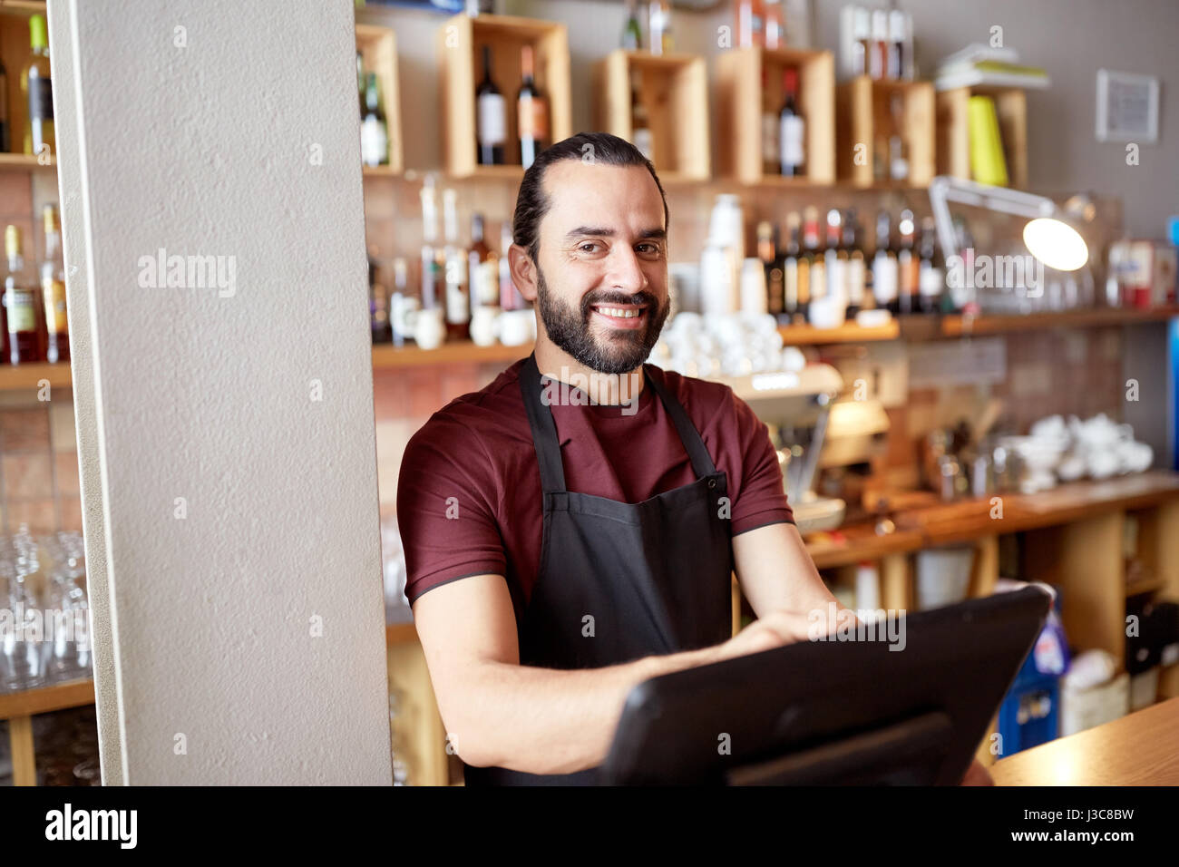 happy man or waiter at bar cashbox Stock Photo