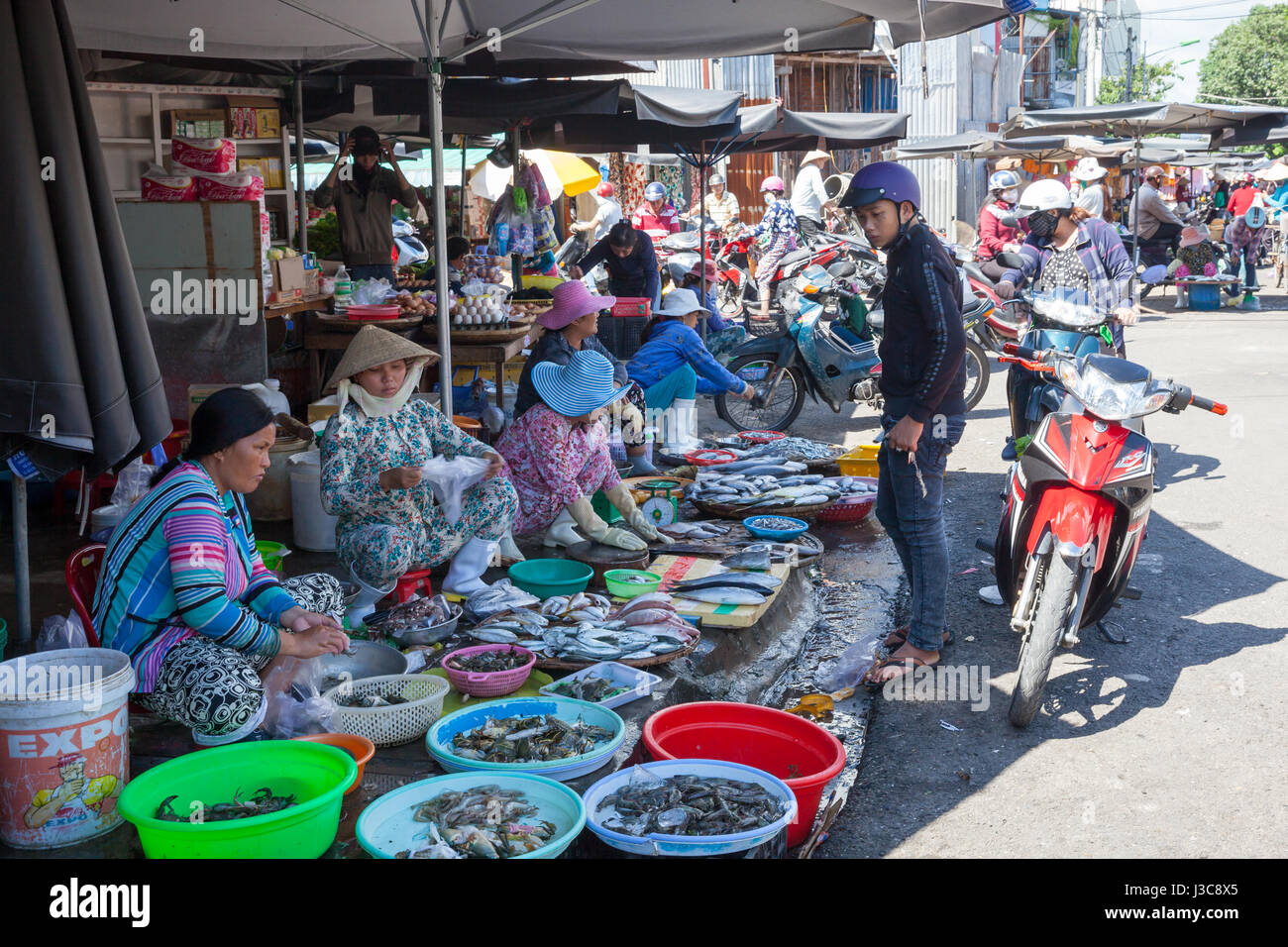 NHA TRANG, VIETNAM - DECEMBER 12: Women are selling seafood at the wet market on December 12, 2015 in Nha Trang, Vietnam. Stock Photo
