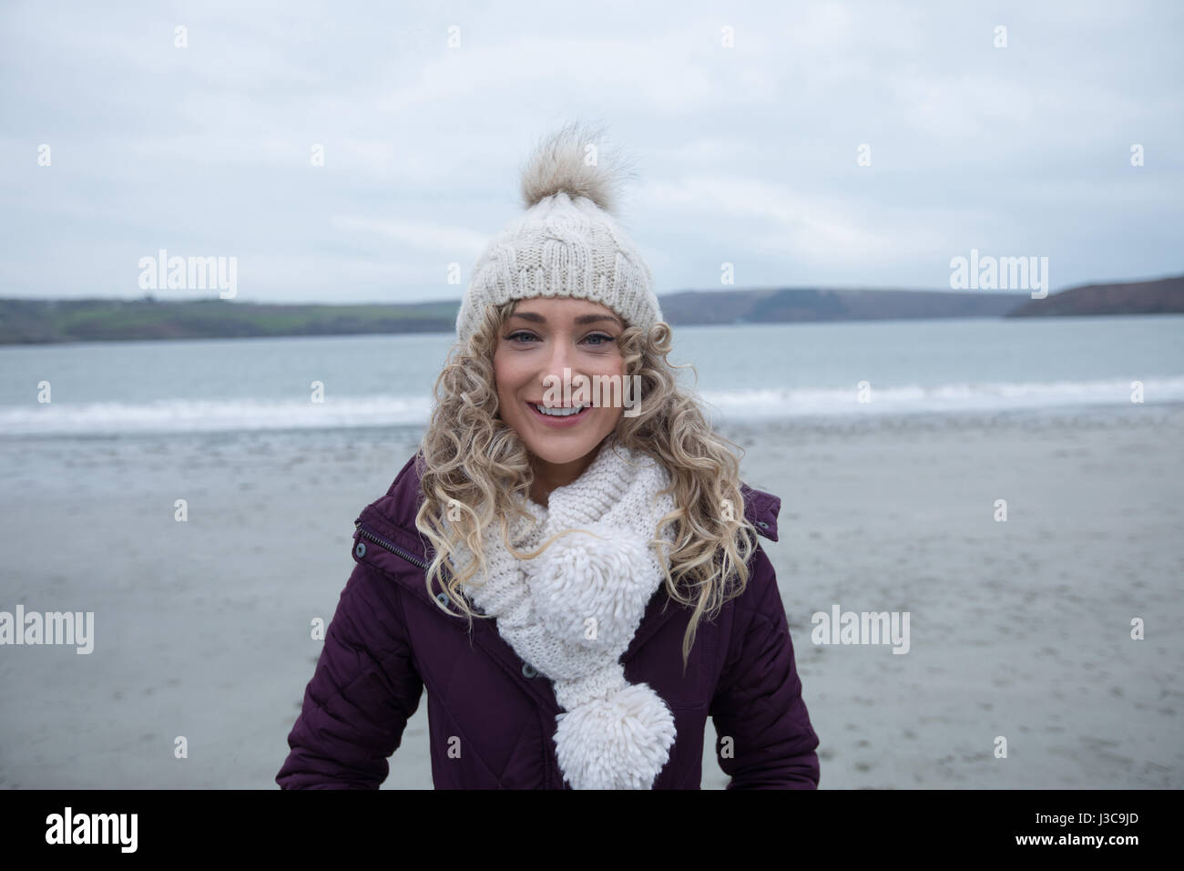Portrait of woman standing on the beach Stock Photo - Alamy