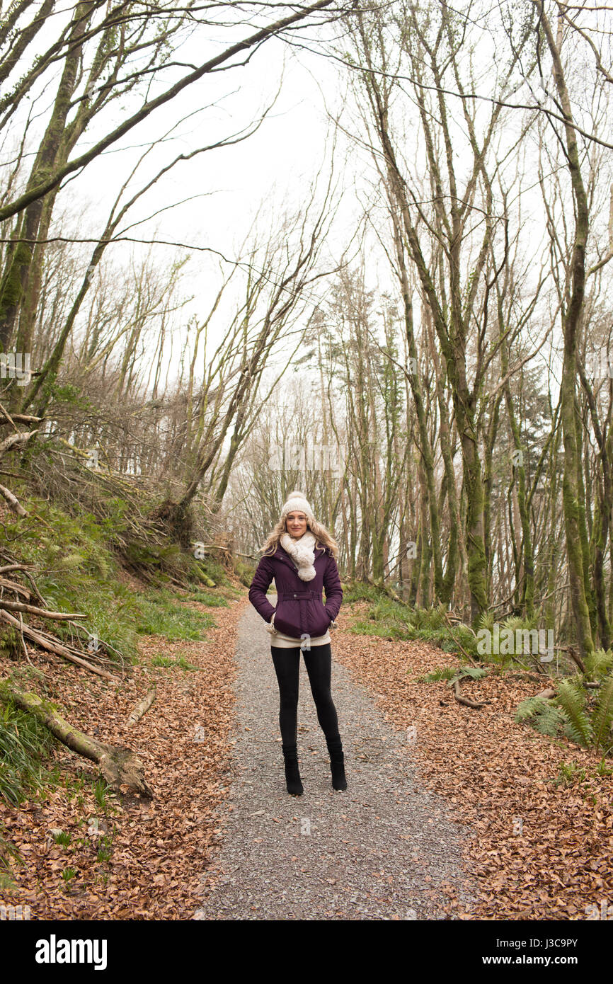 Portrait of woman standing in the forest Stock Photo - Alamy