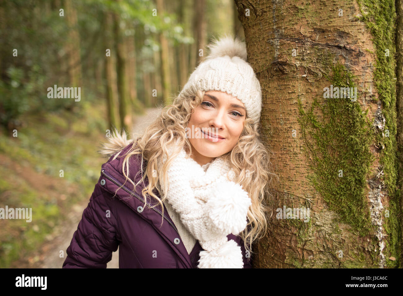 Portrait of woman standing in the forest Stock Photo - Alamy