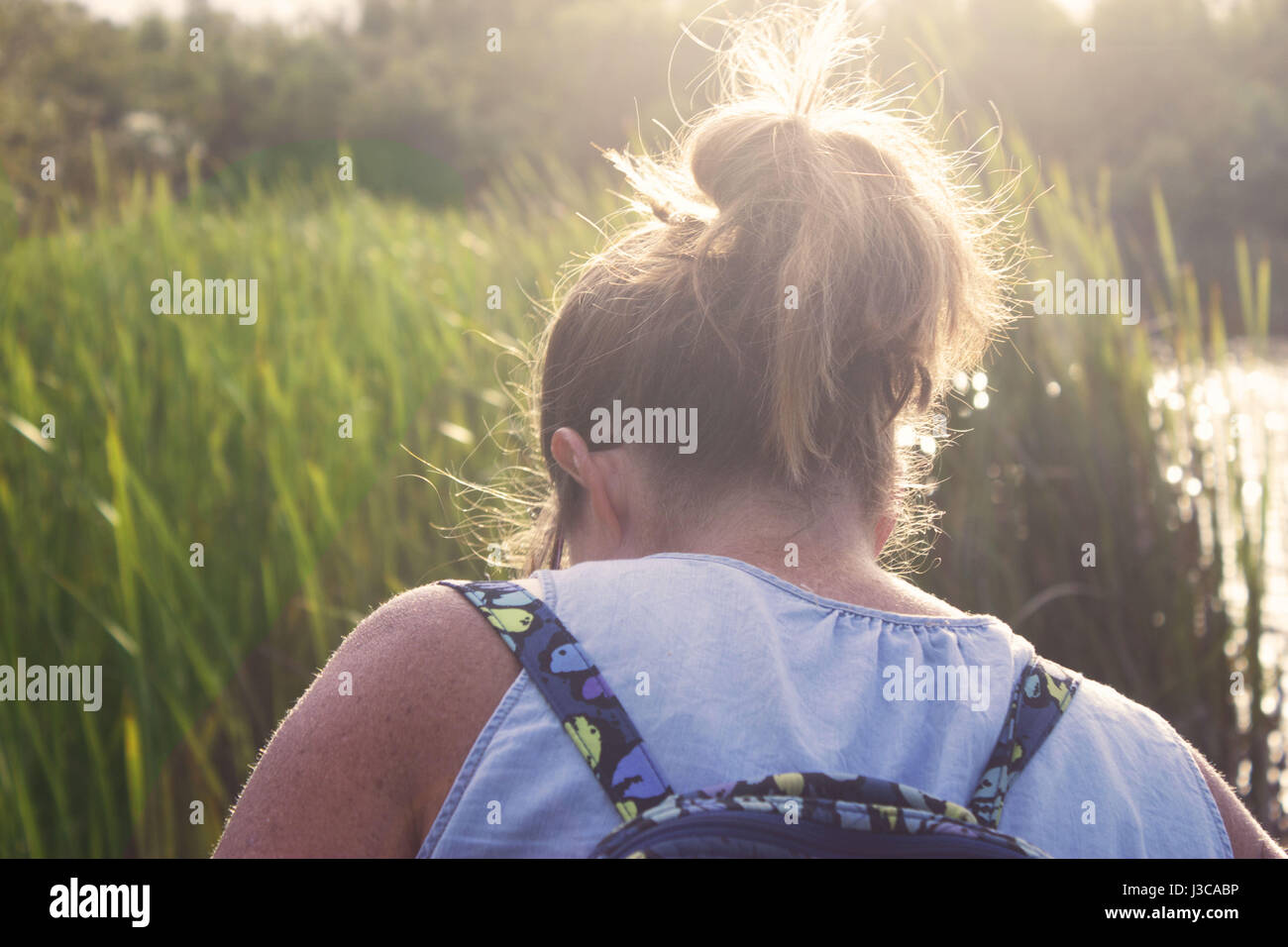 Woman exploring in the grass. Stock Photo