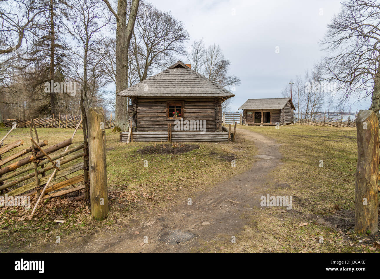 Agricultural buildings of wood and stone with thatched roofs, installed on Estonian ethnographic territory under the open sky. Rocca al Mare Stock Photo